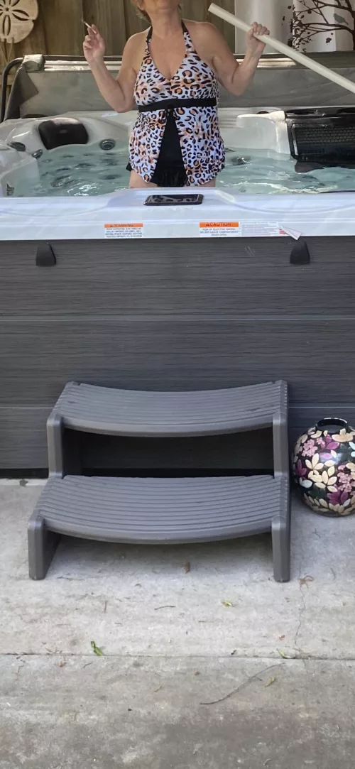 Gilf cleaning the hot tub