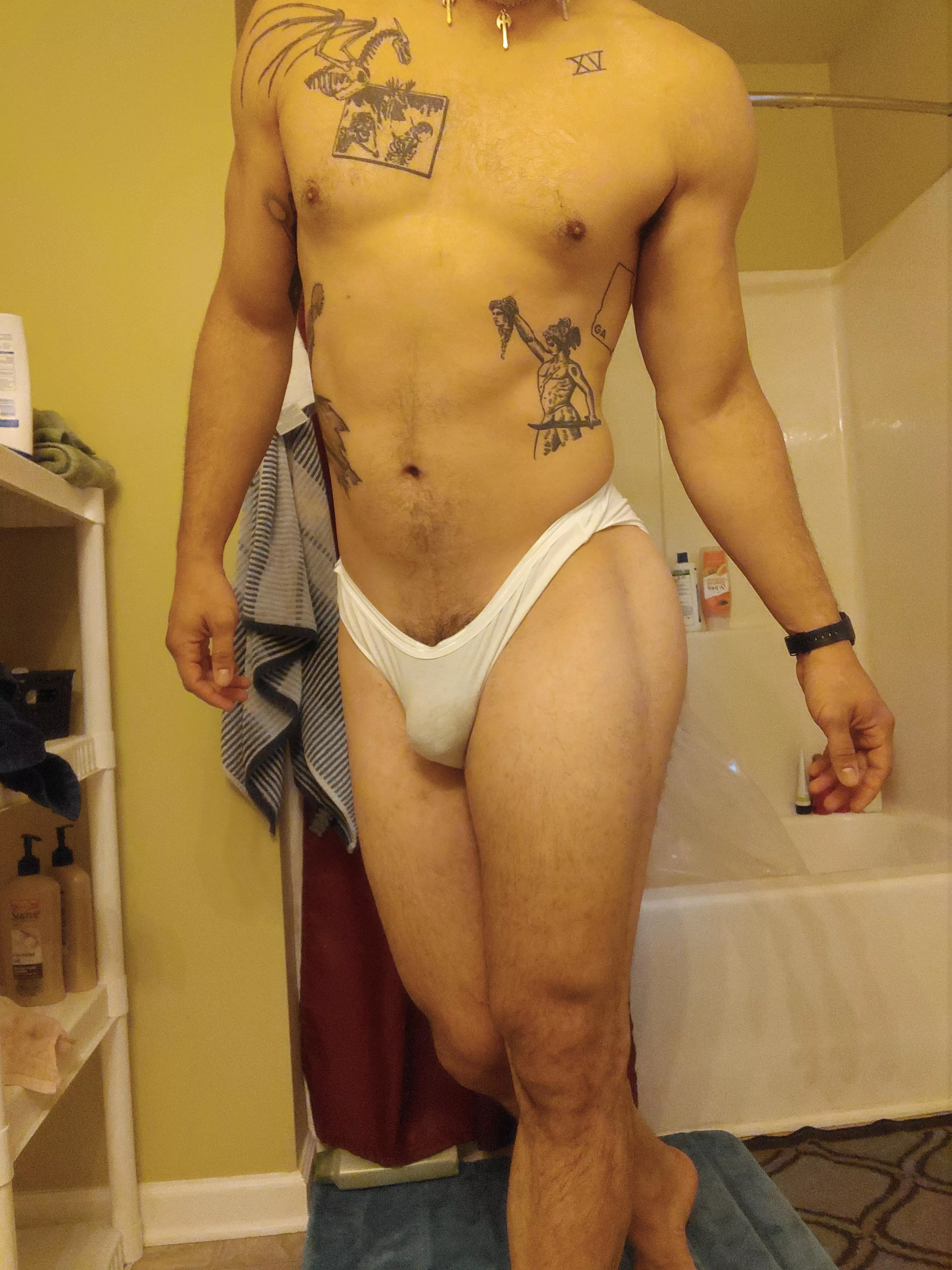 The white underwear contrasts the tats nicely