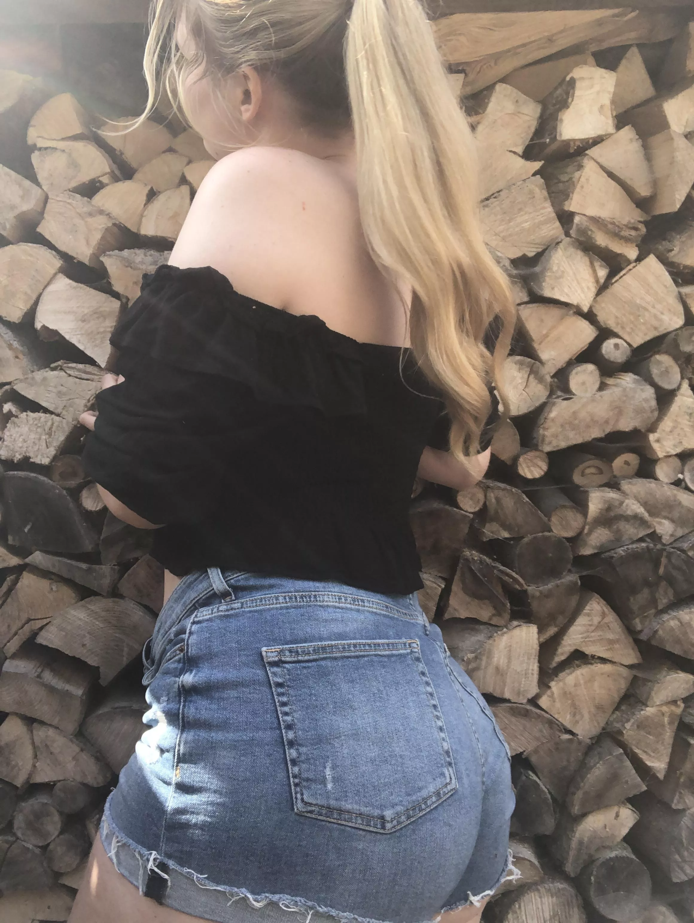 Thick white girl standing in front of some 🪵