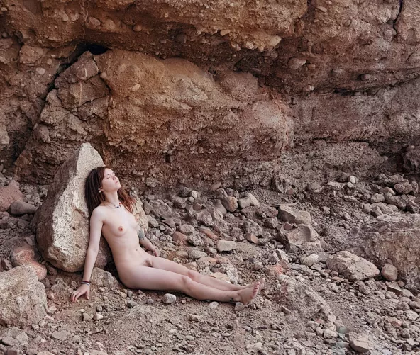 walking on a pebble beach, relaxing by a stone